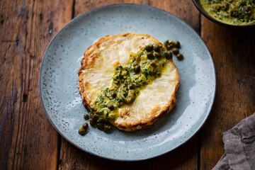 Roasted celeriac steak with capers and herb sauce