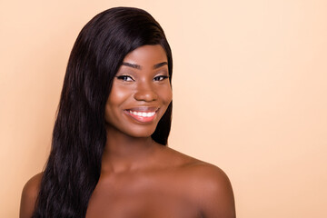 Photo of shiny cute dark skin nude woman smiling empty space isolated beige color background