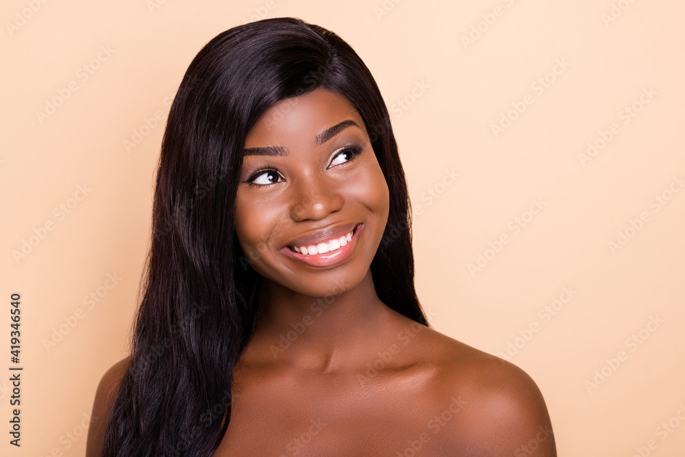 Sticker Photo of dreamy charming dark skin naked lady smiling looking empty space isolated beige color background