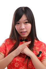 beauty woman wear red cheongsam looking and smile in chinese new year
