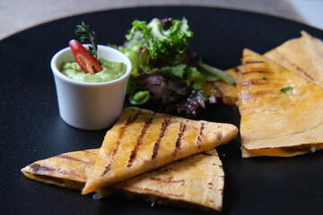 quesadilla on a dark gray plate. photos with a small depth of field