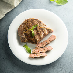 Grilled beef steak with fresh basil