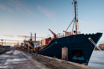 Cargo ship in docklands london sunset.