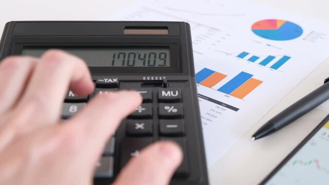 Man Counting on Calculator and Showing Buy on Screen. Close-up Shot