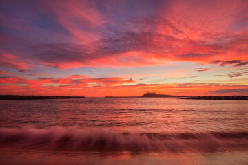 Beautiful, autumn ,sunrise over Newcastle Harbour. Nobbys Lighthouse in the distance. Hunter Valley Region of N.S.W. Australia.