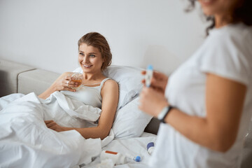 Obraz premium Positive delighted woman feeling better after bed rest