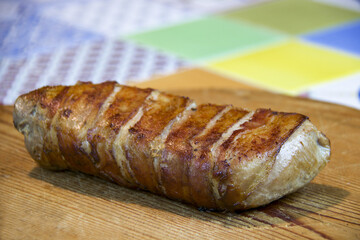 pork fillet roasted covered with slices of bacon