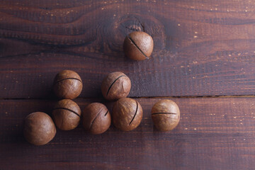 Macadamia nuts on a brown wooden table