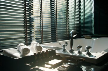 Evening sun light outside wooden window blinds, sunshine and shadow on window blinds , decorative...