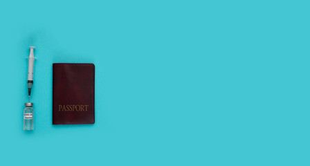 Medicine concept: top view (flat lay) of syringe with vaccine and passport on blue background....