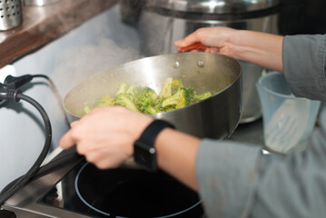 Close up photo of chef preparing broccoli for dinner