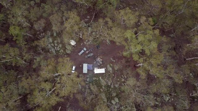 Aerial Top Ascend: Friends And Vehicles At Campsite In Forest