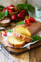 Delicious summer dessert strawberry pie with strawberry sugar icing, sweet delicious strawberry birthday cake on rustic table. Copy space.