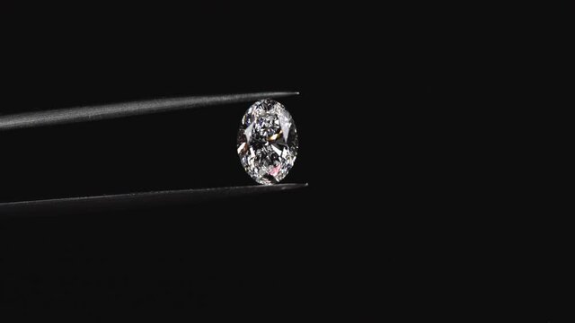 Oval shape diamond with tweezers 4k
