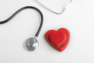 Two red hearts and stethoscope on white background. Heart transplant.