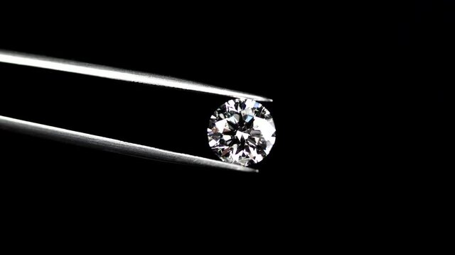 Round brilliant cut diamond with tweezers 4k