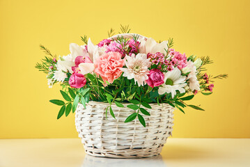 Bunch of fresh summer flowers on the yellow background