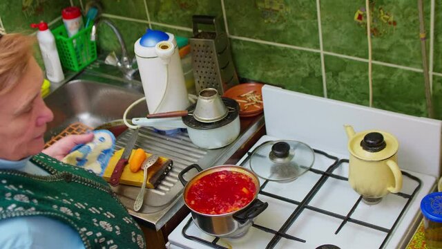 Close up and up view of seniour woman busy with hosehold chores. Retirement at home.