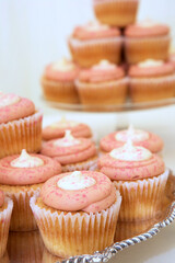  Pink cupcakes decorated with white icing and sprinkles