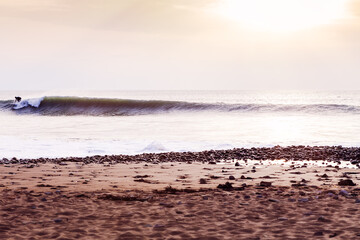 Surfer riding a wave out of shot, Cornwall, Uk