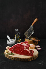 Raw top round roast beef steak on dark background
