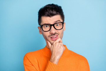 Photo of young man arm on chin wear glasses sullen face wear sweater isolated on blue color...