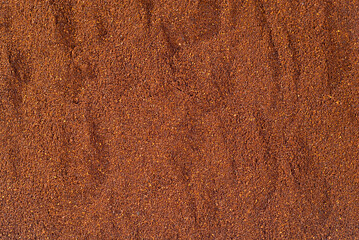 Texture of ground coffee close up. Lots of coffee granules in a pile.