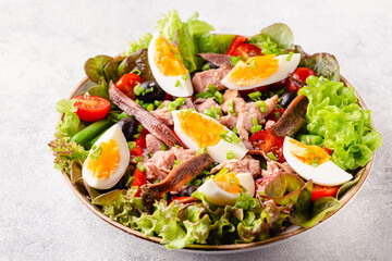 salad Nicoise with tuna, eggs, green beans, tomatoes,  olives, lettuce and anchovies