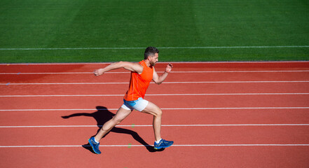 Obraz premium Morning workout. energetic and sporty. marathon speed energy. muscular man in motion. athletic man compete in sprint. sport healthy lifestyle. fitness training outdoor. runner run on running track