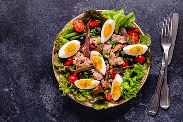 salad Nicoise with tuna, eggs, green beans, tomatoes,  olives, lettuce and anchovies