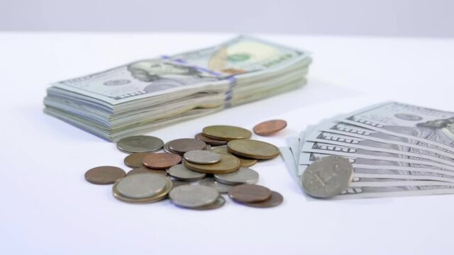 coins falling onto bills of hundreds