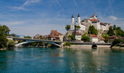 Fototapeta na wymiar town with river, bridge and church on the rock / Aarburg, Switzerland
