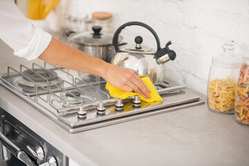 Close up of a housewife doing cleaning the gas stove