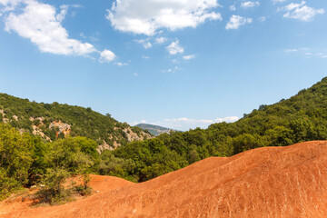Fototapeta premium Red clay terrain, a rare geological phenomenon, as seen near Preveza city, in Epirus region, Greece, Europe.