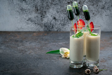 Cream mousse or yogurt in a glass with mint and basil. Dessert for catering service or celebration