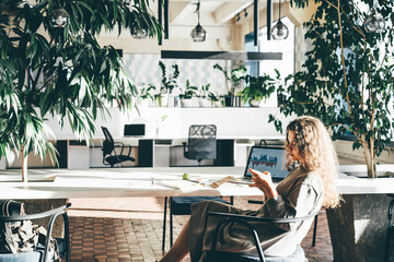 Creative woman working online at a co-working space.