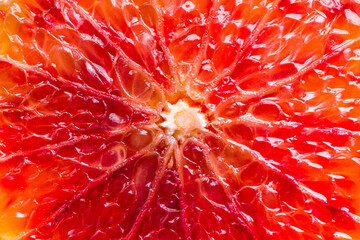 Bloody red sicilian orange pulp texture background. Macro photo of red orange fruit. Citrus friut close up