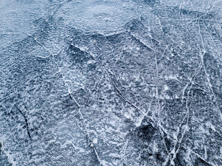 Frosty pattern on the river. Aerial drone view. Sunny winter day, thin ice on the river.