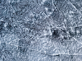 Frosty pattern on the river. Aerial drone view. Sunny winter day, thin ice on the river.