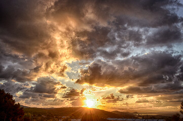 Sunrise in a partly cloudy sky