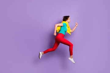 Fototapeta na wymiar Full length profile photo of lady jump run wear tied jumper t-shirt pants footwear isolated purple color background