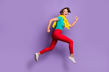 Full length photo of excited lady jump run wear knotted pullover t-shirt pants footwear isolated violet color background