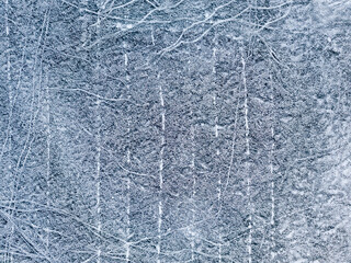 Frosty pattern on the river. Aerial drone view. Sunny winter day, thin ice on the river.