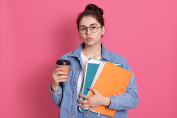 Lovely dark dark haired schoolgirl keeps lips rounded, flirts with somebody at school, wears round...