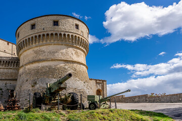 Fototapeta na wymiar Ancient cannons protect the fortress of the rocca di San Leo on a sunny day, Rimini, Italy