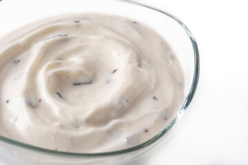 Stracciatella yogurt in transparent bowl isolated on white background	