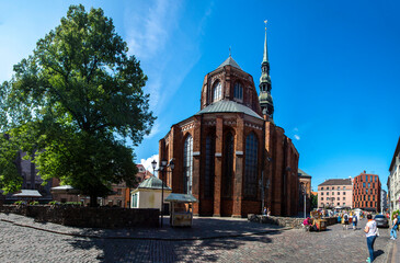 summer cityscape of old town square with big ancient church on it 