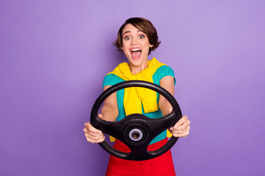 Photo of crazy excited lady open mouth hold steering wheel wear tied pullover t-shirt isolated violet color background
