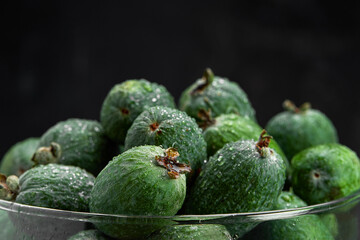 Feijoa whole on black background. Exotic fruit. Selective focus. Closeup.
