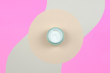 Top view of an open jar of cream on a colored background. Organic cosmetics skincare product